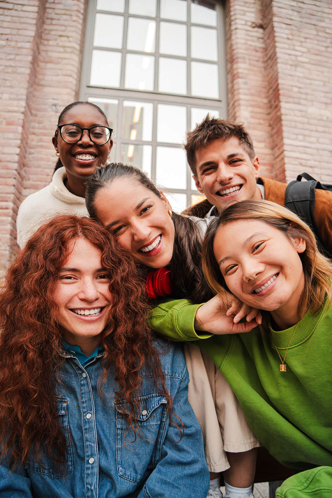 A group of five  high school age students smiling at the camera