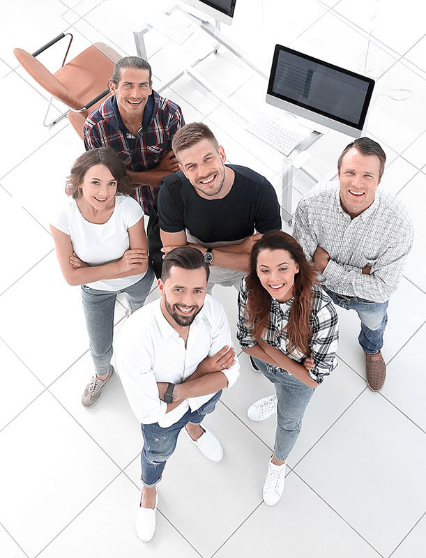 A group of alumni looking up at the camera